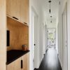Main hallway, Cali Bamboo engineered floating bamboo flooring, Plumen 003 Dimmable LED Pendant Set, Nest smoke alarm, Kohler soaking tub and ply/Richlite cabinetry by Mike Gagne.